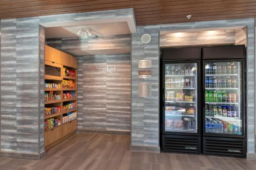 a store aisle with a refrigerator and drinks at Fairfield by Marriott Inn & Suites San Francisco Pacifica in Pacifica