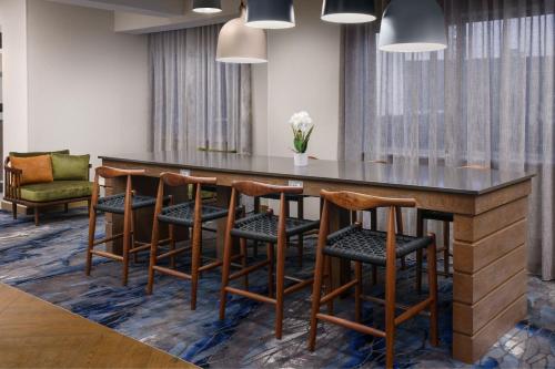 a bar in a room with chairs and a table at Fairfield Inn by Marriott Joliet South in Joliet