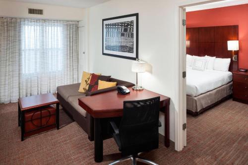 a hotel room with a desk and a bed at Residence Inn Jackson Ridgeland in Ridgeland