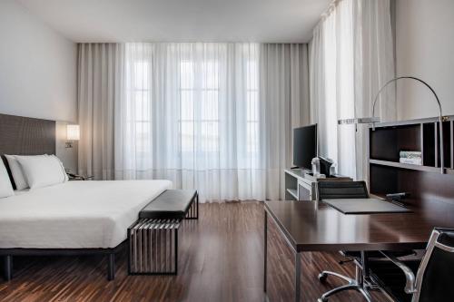 a hotel room with a bed and a desk at AC Hotel Torino by Marriott in Turin