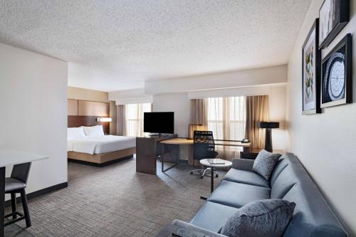 a hotel room with a couch and a bed at Residence Inn by Marriott Austin The Domain Area in Austin