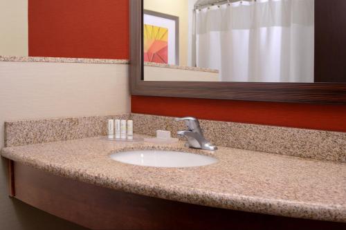 a bathroom counter with a sink and a mirror at Courtyard by Marriott Galveston Island in Galveston