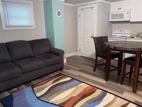 a living room with a couch and a table at Cute 1 Bdrm House that sleeps 3 in Petersburg