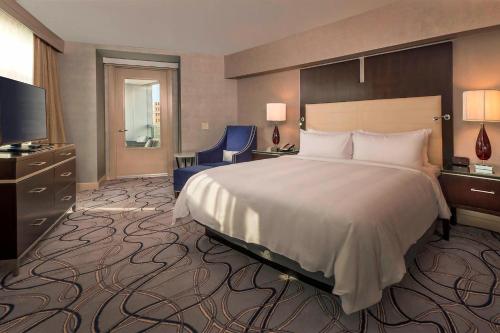 a hotel room with a large bed and a television at Marriott Marquis Washington, DC in Washington, D.C.