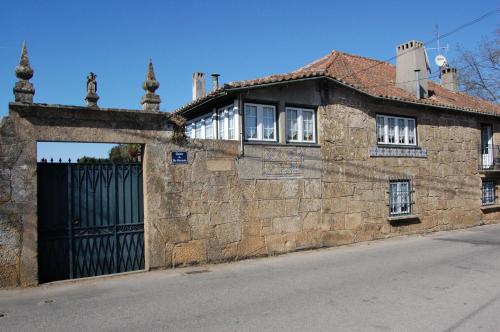 an old stone building with a gate in front of it at Casa da Quinta De S. Martinho in Vila Real