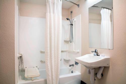 a white bathroom with a sink and a shower at Fairfield Inn and Suites by Marriott Lakeland Plant City in Plant City
