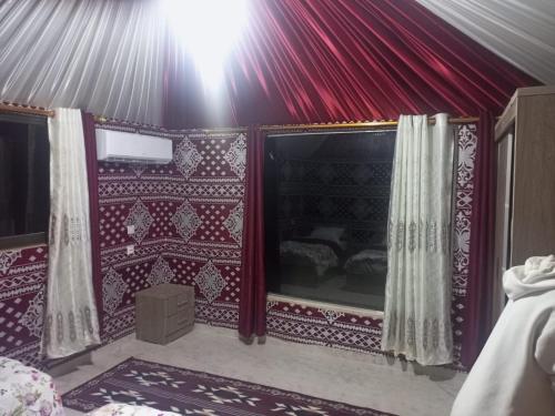 a room with a red and white wall at Yara camp in Wadi Rum