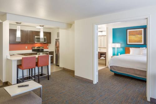 a hotel room with a bed and a kitchen at Residence Inn Portland Hillsboro in Hillsboro