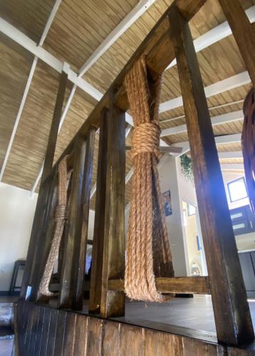 a group of wooden beams with ropes hanging from them at Blue House Joyuda in Cabo Rojo