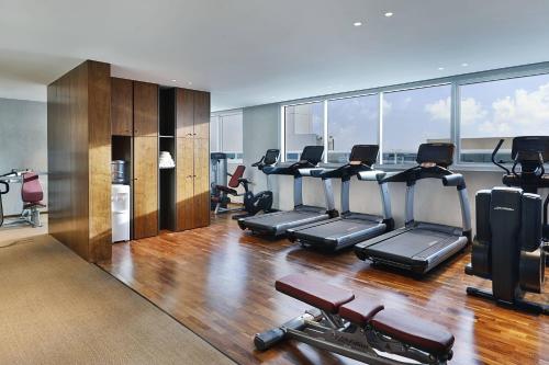 a gym with treadmills and exercise equipment in a building at Courtyard by Marriott Dubai, Al Barsha in Dubai