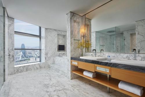 a bathroom with two sinks and a large window at Ningbo Marriott Hotel in Ningbo