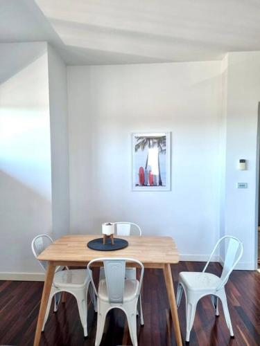 a dining room table with two chairs and a wooden table at Aspendale Beach Escape -Walk To Mordialloc in Aspendale