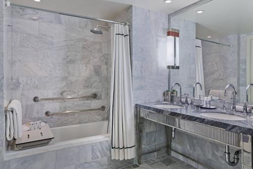 a bathroom with two sinks and a shower at St. Regis Aspen Resort in Aspen