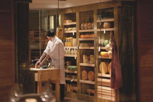a man in a kitchen preparing food in a bakery at The Ritz-Carlton, Toronto in Toronto