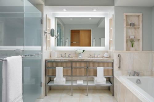 a bathroom with a sink and a mirror at The Ritz-Carlton, Toronto in Toronto