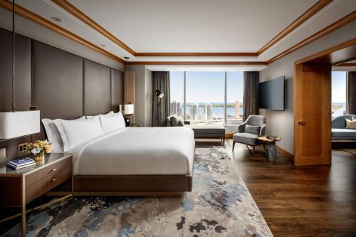 a hotel room with a bed and a large window at The Ritz-Carlton, Toronto in Toronto