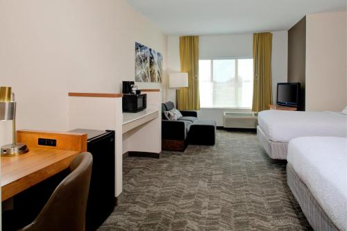 a hotel room with two beds and a desk at SpringHill Suites by Marriott Memphis East Galleria in Memphis