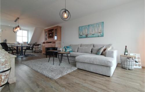 a living room with a couch and a table at Amazing Home In Stavenisse With Sauna in Stavenisse