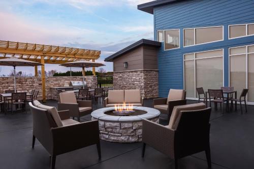 a patio with a fire pit and chairs and tables at Residence Inn by Marriott Rehoboth Beach in Rehoboth Beach
