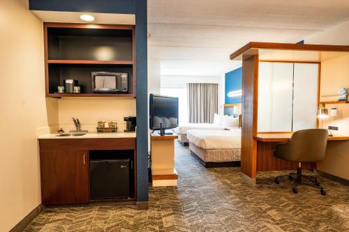 a hotel room with a room with a bed and a desk at Springhill Suites by Marriott San Antonio Alamo Plaza/Convention Center in San Antonio