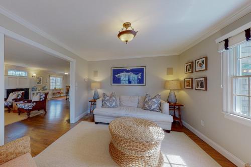 a living room with a white couch and a chair at Cotuit Mannor in Cotuit