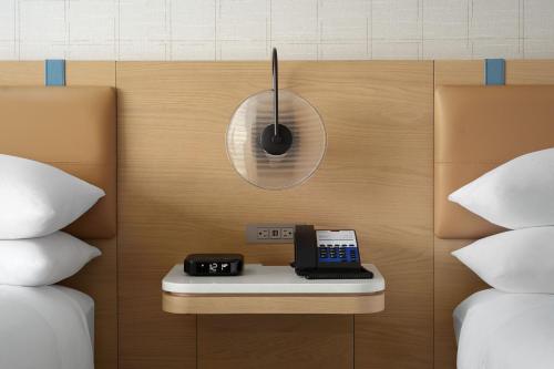 a clock on a wall next to two beds at Delta Hotels by Marriott Vancouver Delta in Delta