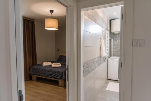 a room with a bed and a door leading to a bathroom at Apartman Mila23 in Rospi Ćuprija