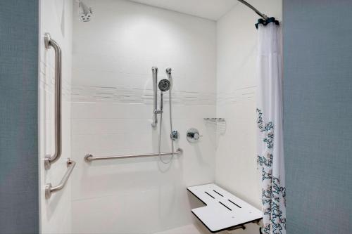a white bathroom with a shower and a sink at Residence Inn by Marriott Kingston in Kingston
