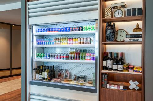 an open refrigerator filled with lots of drinks at Residence Inn by Marriott The Hague in The Hague