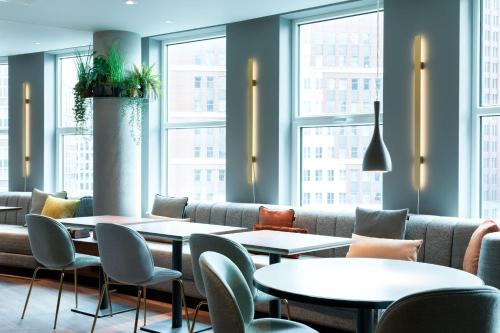 a restaurant with tables and chairs and windows at Residence Inn by Marriott The Hague in The Hague