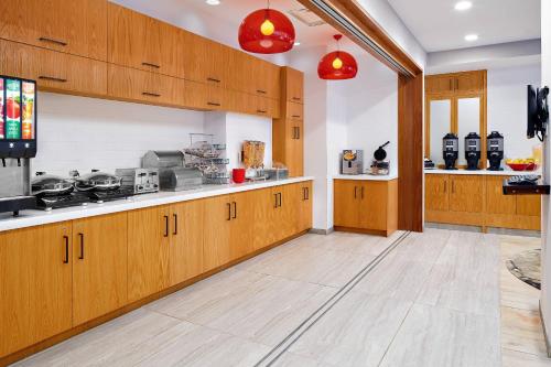 a large kitchen with wooden cabinets and appliances at TownePlace Suites by Marriott New York Manhattan/Times Square in New York