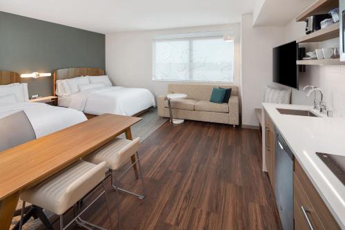 a small hotel room with two beds and a kitchen at Element Bloomington Mall of America in Bloomington