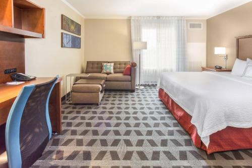 a hotel room with a bed and a couch at TownePlace Suites Tucson Airport in Tucson