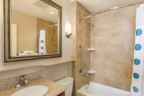 a bathroom with a sink and a toilet and a mirror at TownePlace Suites Tucson Airport in Tucson