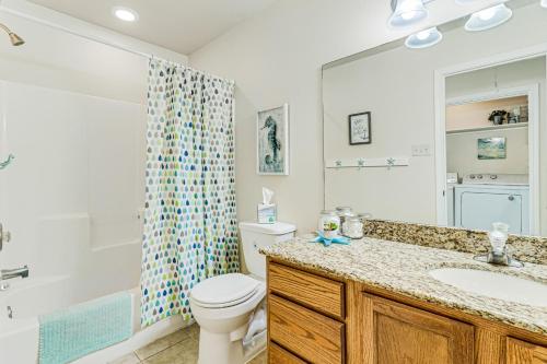 a bathroom with a toilet and a sink and a shower at Feelin' Beachy in Padre Island