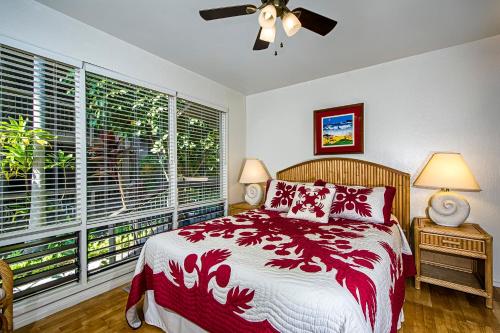 a bedroom with a bed and a large window at Kanaloa At Kona 701 in Kailua-Kona