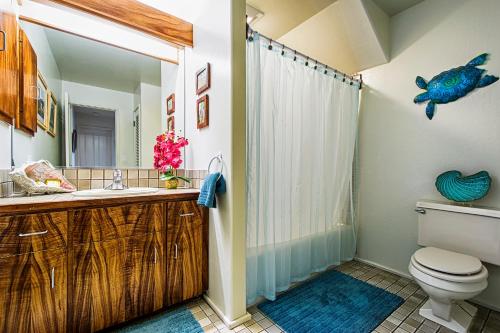a bathroom with a shower and a toilet and a sink at Kanaloa At Kona 701 in Kailua-Kona