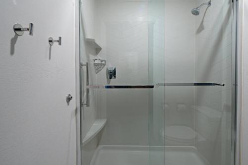 a bathroom with a glass shower with a toilet at Fairfield by Marriott Inn & Suites Seattle Sea-Tac Airport in SeaTac