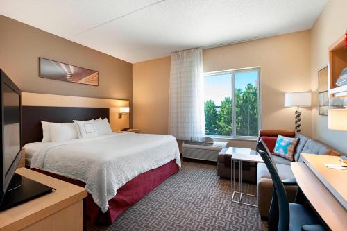 a hotel room with a bed and a window at TownePlace Suites by Marriott Rock Hill in Rock Hill