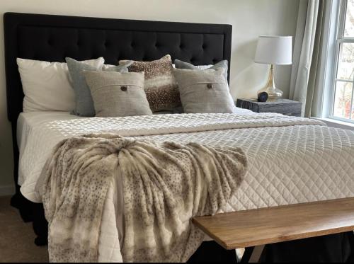 a bedroom with a large bed with a blanket and pillows at Vine City Home - Duplex - 3 Mins From GWCC & Mercedes- Benz Stadium in Atlanta
