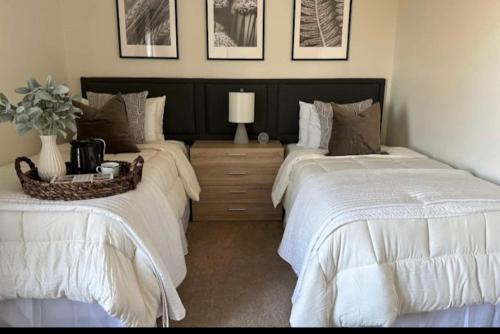 two beds sitting next to each other in a bedroom at Vine City Home - Duplex - 3 Mins From GWCC & Mercedes- Benz Stadium in Atlanta