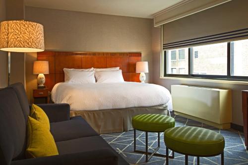 a hotel room with a bed and a couch at Courtyard by Marriott New York Manhattan/ Fifth Avenue in New York