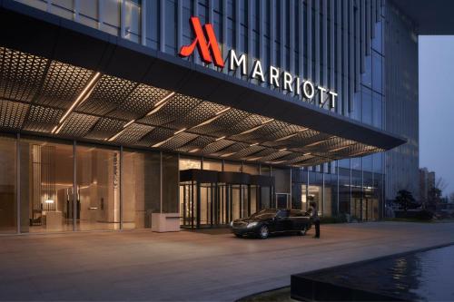 a car parked in front of a marriott building at Jinhua Marriott Hotel in Jinhua
