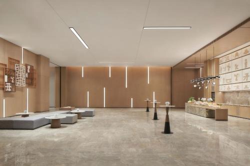 a lobby with couches and tables in a building at Jinhua Marriott Hotel in Jinhua
