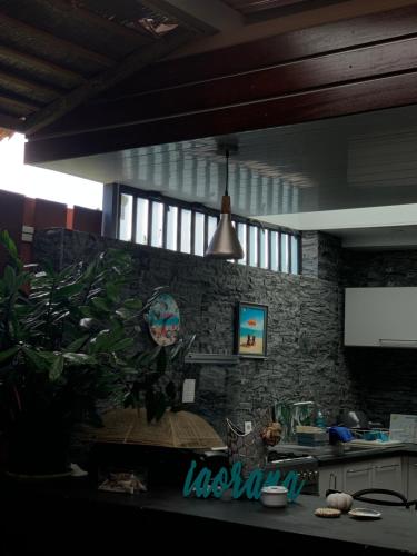 a kitchen with a plant in the corner of a room at TAMANU LODGE in Punaauia