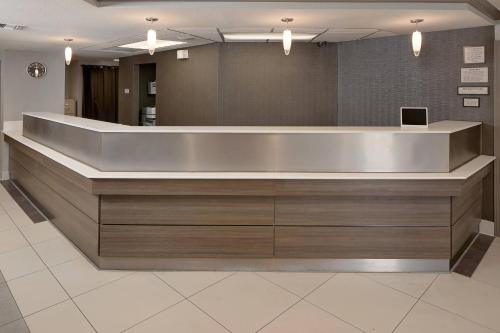 a lobby with a reception desk in a building at Residence Inn Ontario Airport in Ontario