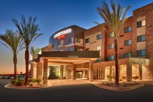 a rendering of the courtyard hotel at dusk at Courtyard by Marriott Phoenix Mesa Gateway Airport in Mesa