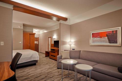 a hotel room with a couch and a bed at Fairfield Inn & Suites by Marriott Grand Mound Centralia in Centralia