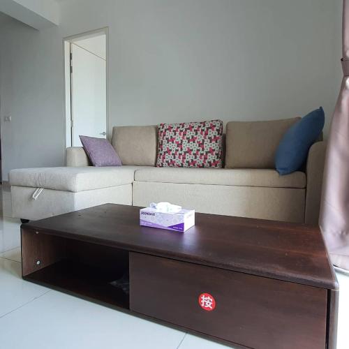 a living room with a couch and a coffee table at Miracle Woodsbury Habour Place Butterworth in Butterworth