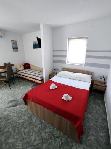 a bedroom with a bed with two towels on it at Apartments with parking space Slatine, Ciovo - 12811 in Slatine